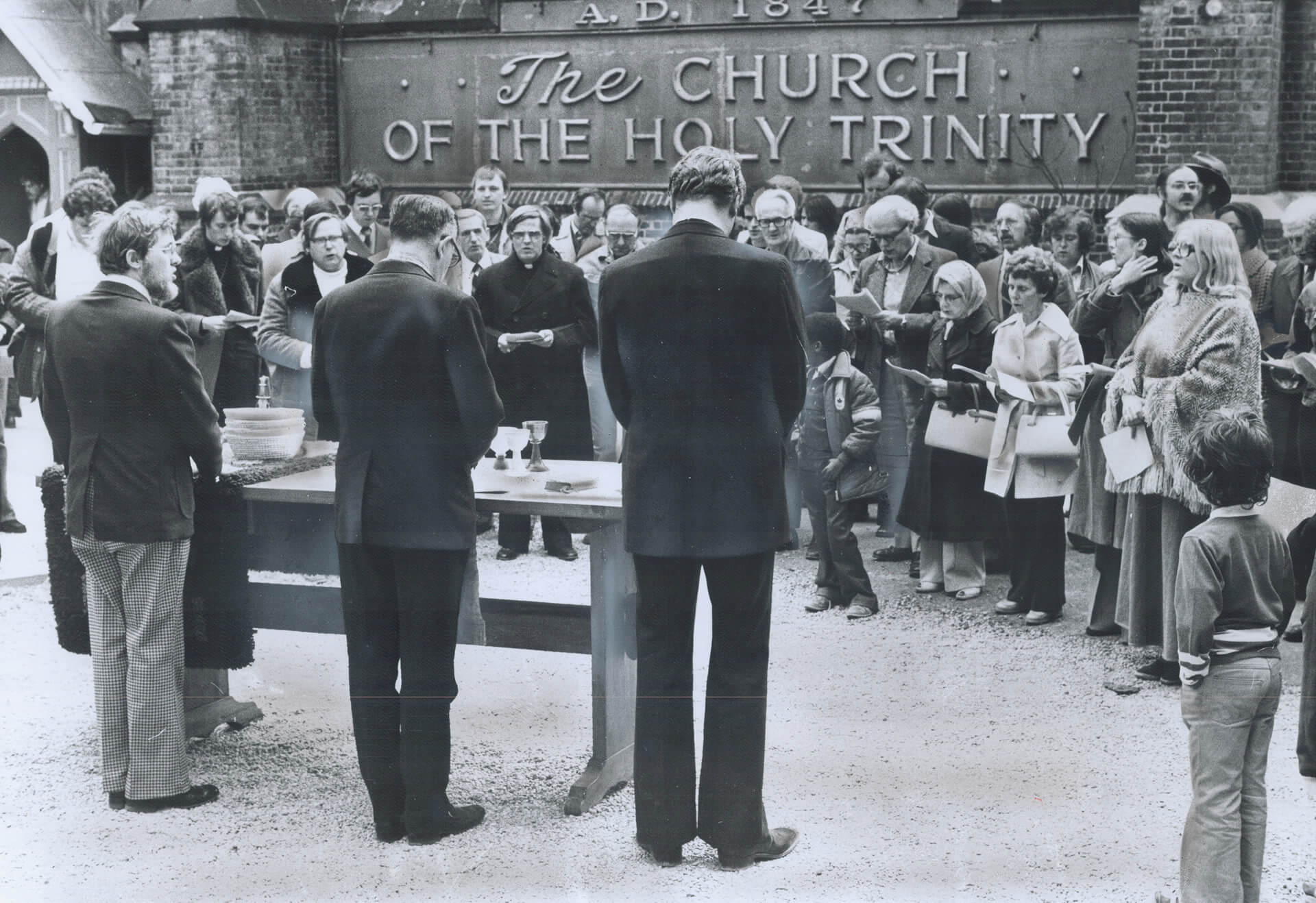 In 1977 members of Holy Trinity gather at the eastern end of the church to give thanks that it wasn't completely destroyed by fire.