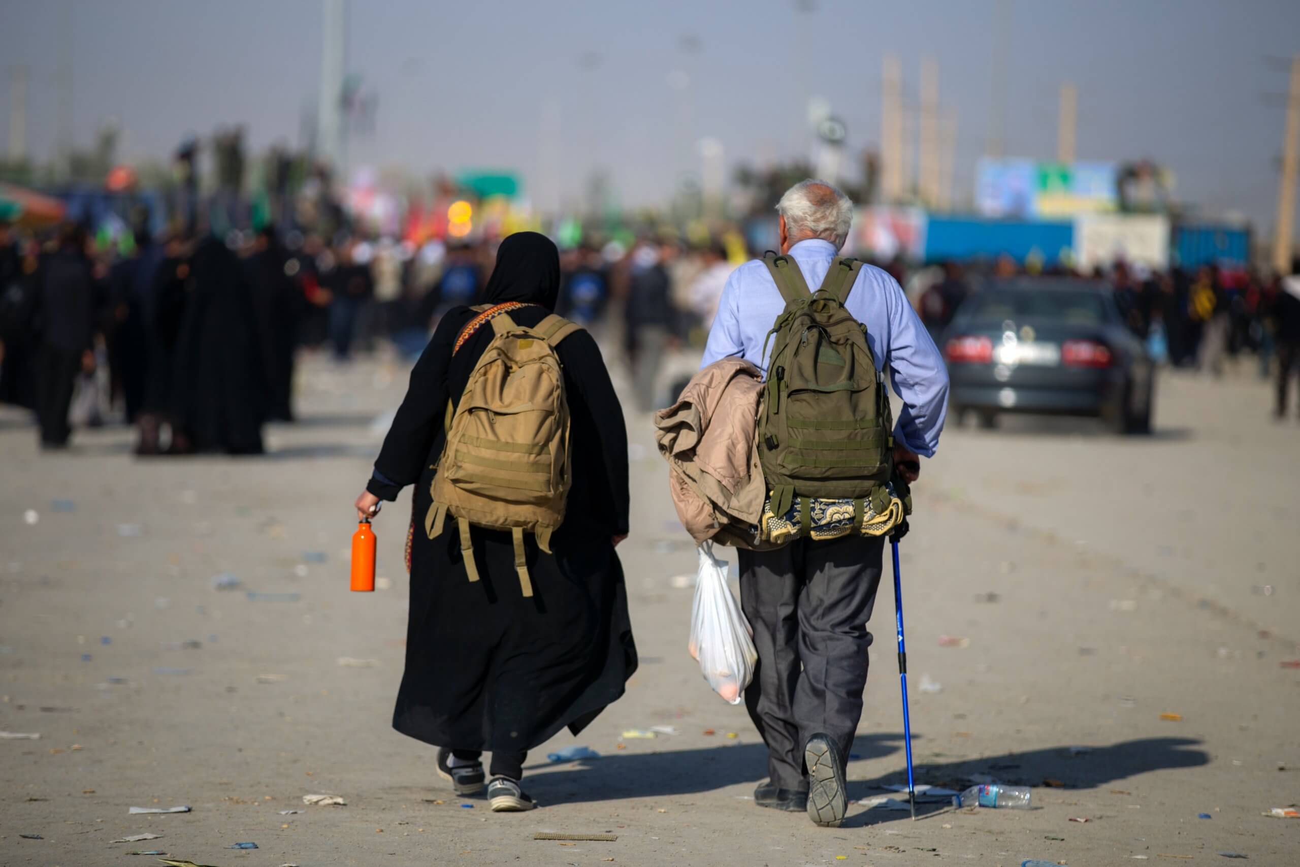 Two older people walk away from the camera. Photo by mostafa meraji on Unsplash