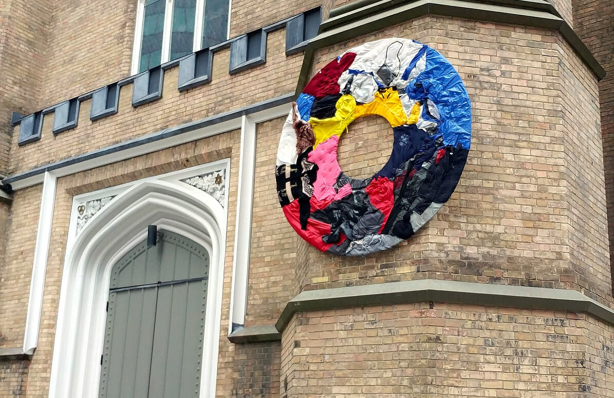 wreath of discarded clothing hanging on the southwest tower of Holy Trinity - photo by W. Whitla