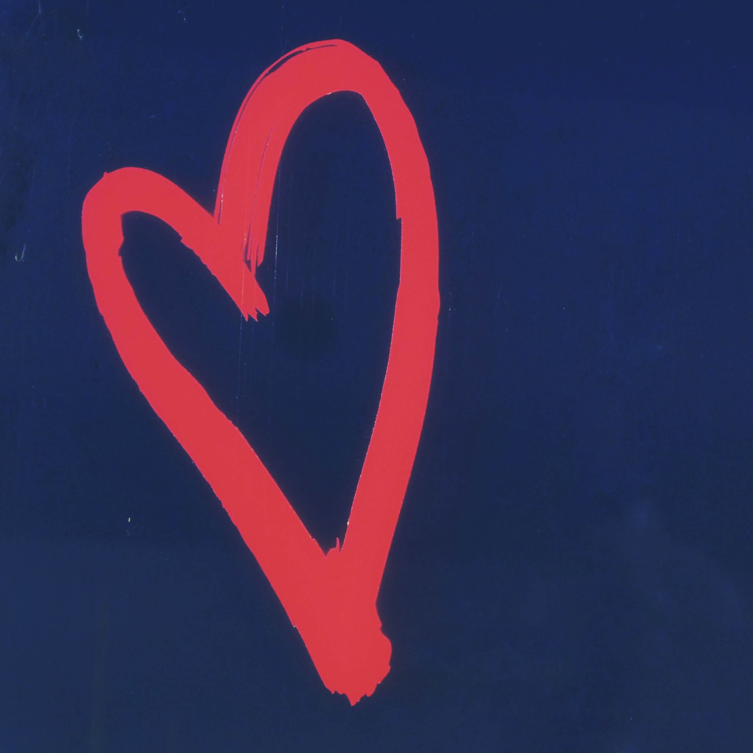 a red painted heart on a blue background