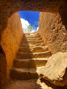 stone steps leading out from an underground dwelling into the sunshine